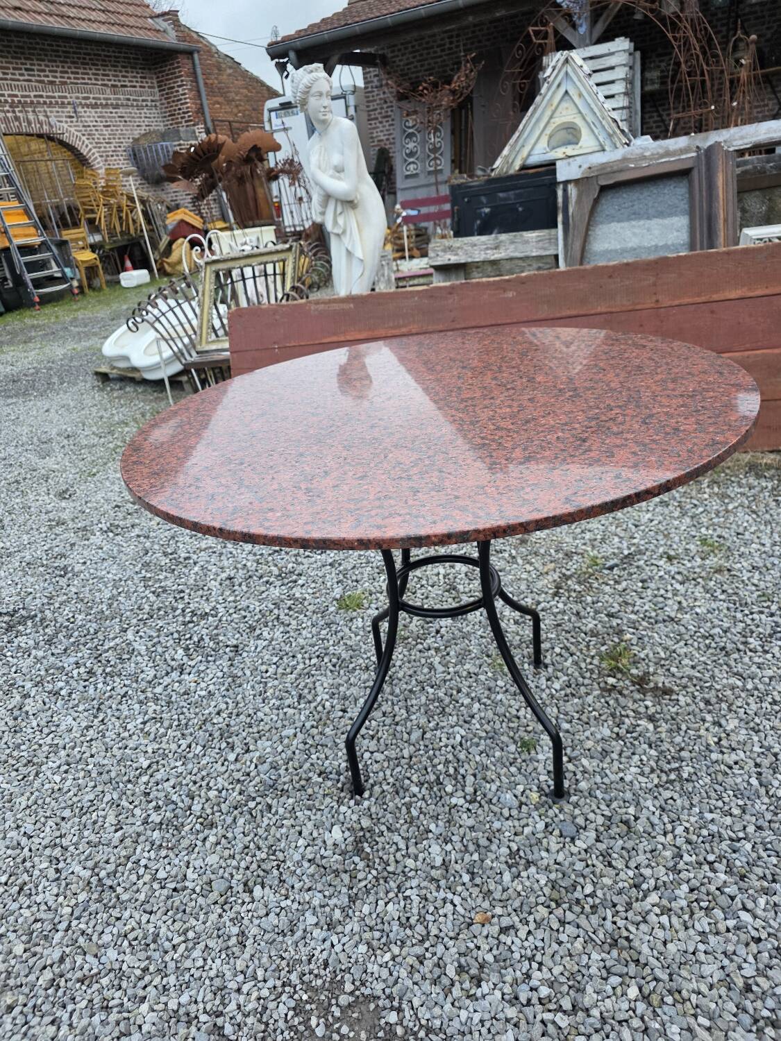 Round marble table with wrought iron base from the mid-20th century.