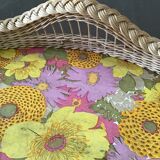 Top of the 60s in rattan braid wood bottom covered with a plastic with pink and yellow flower