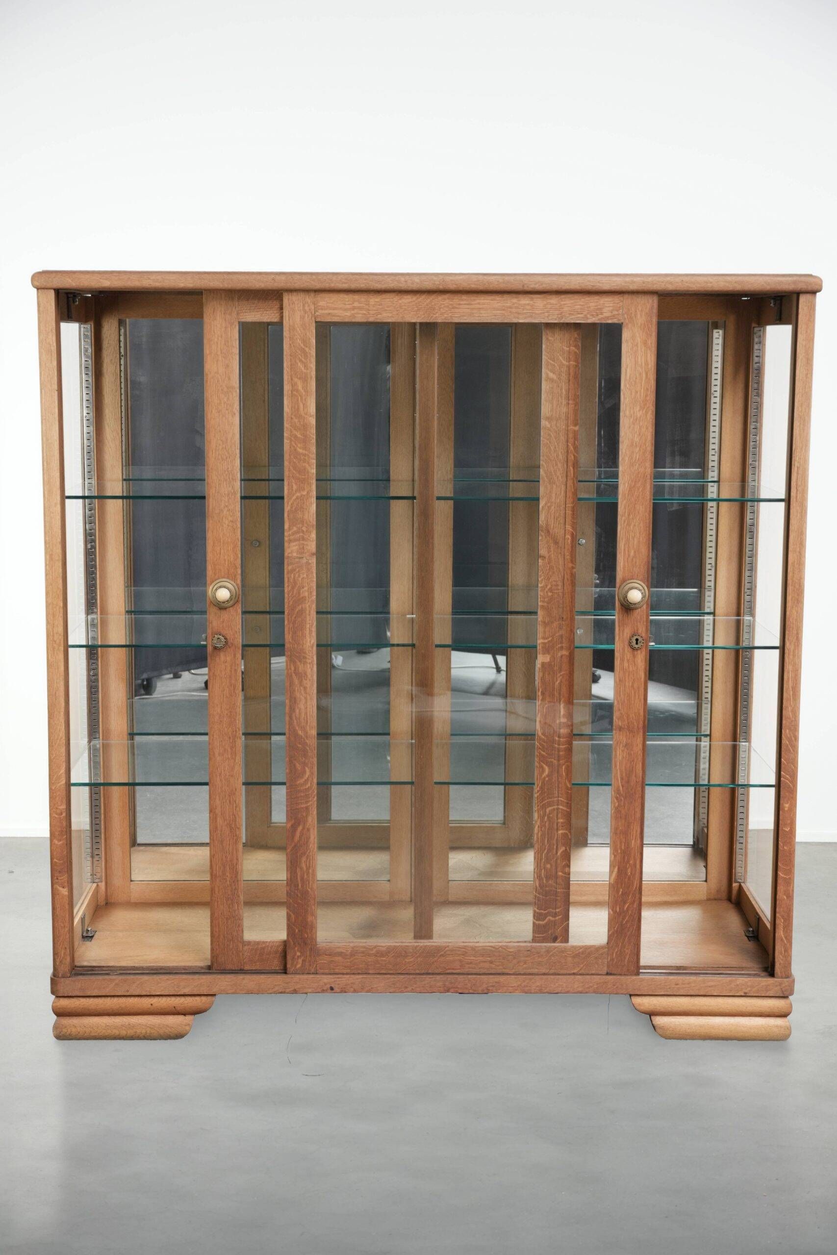 Antique Dutch oak display cabinet with glass shelves and a mirrored back