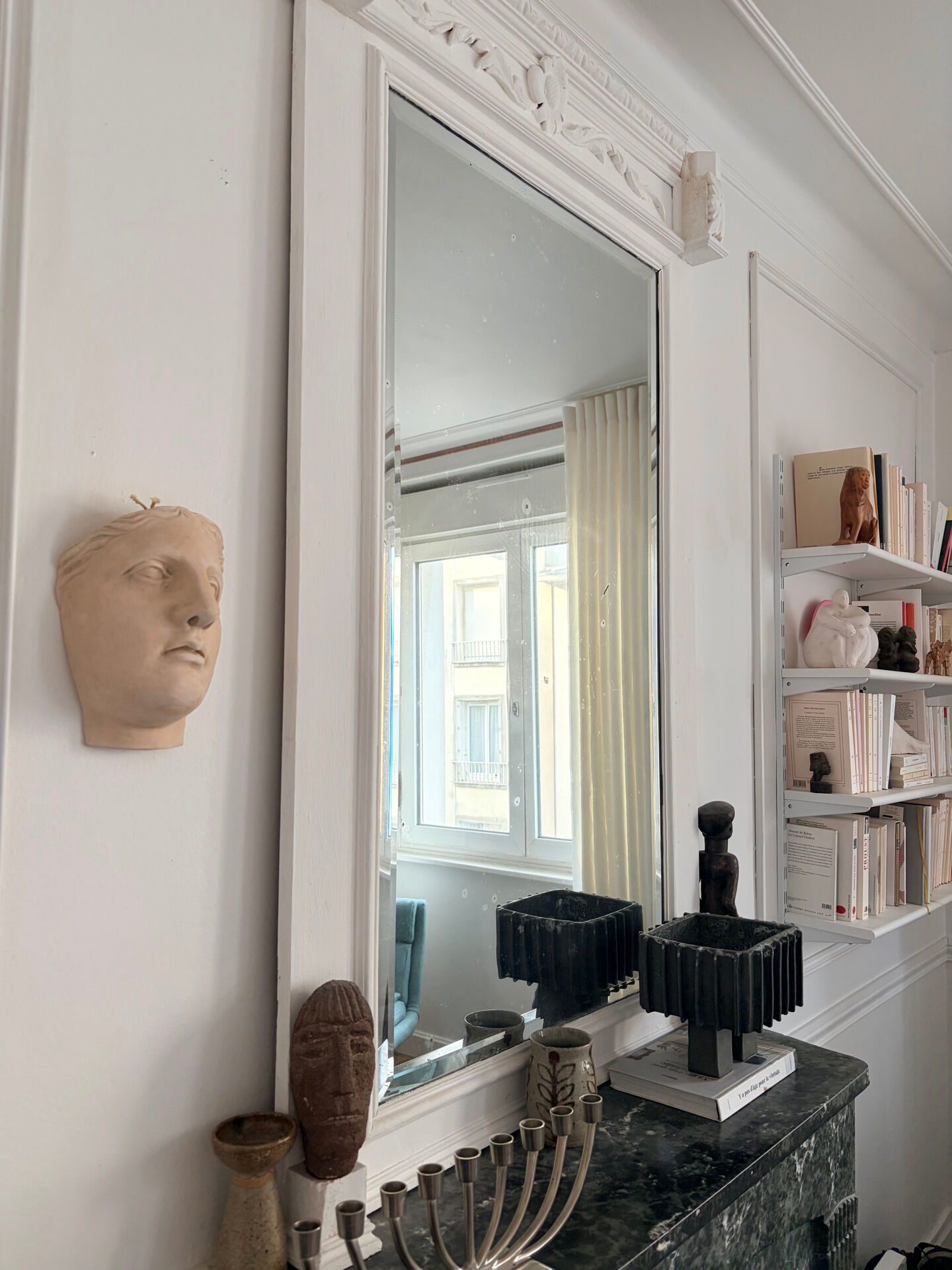 Wall sculpture of the face of the Venus de Milo in plaster.