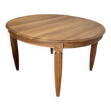 Round dining table with fluted legs in solid wood