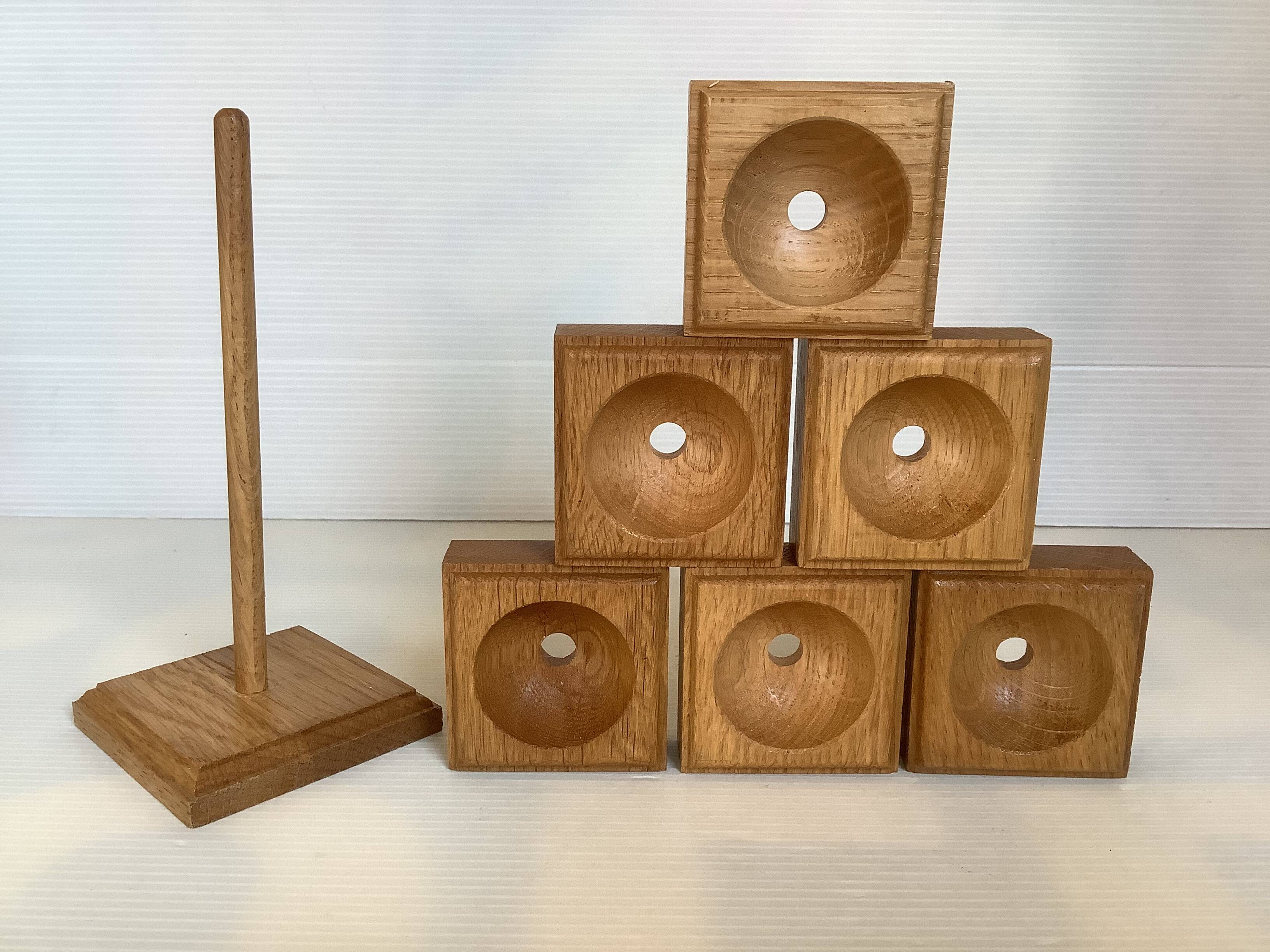 Six wooden egg cups and their Scandinavian style support