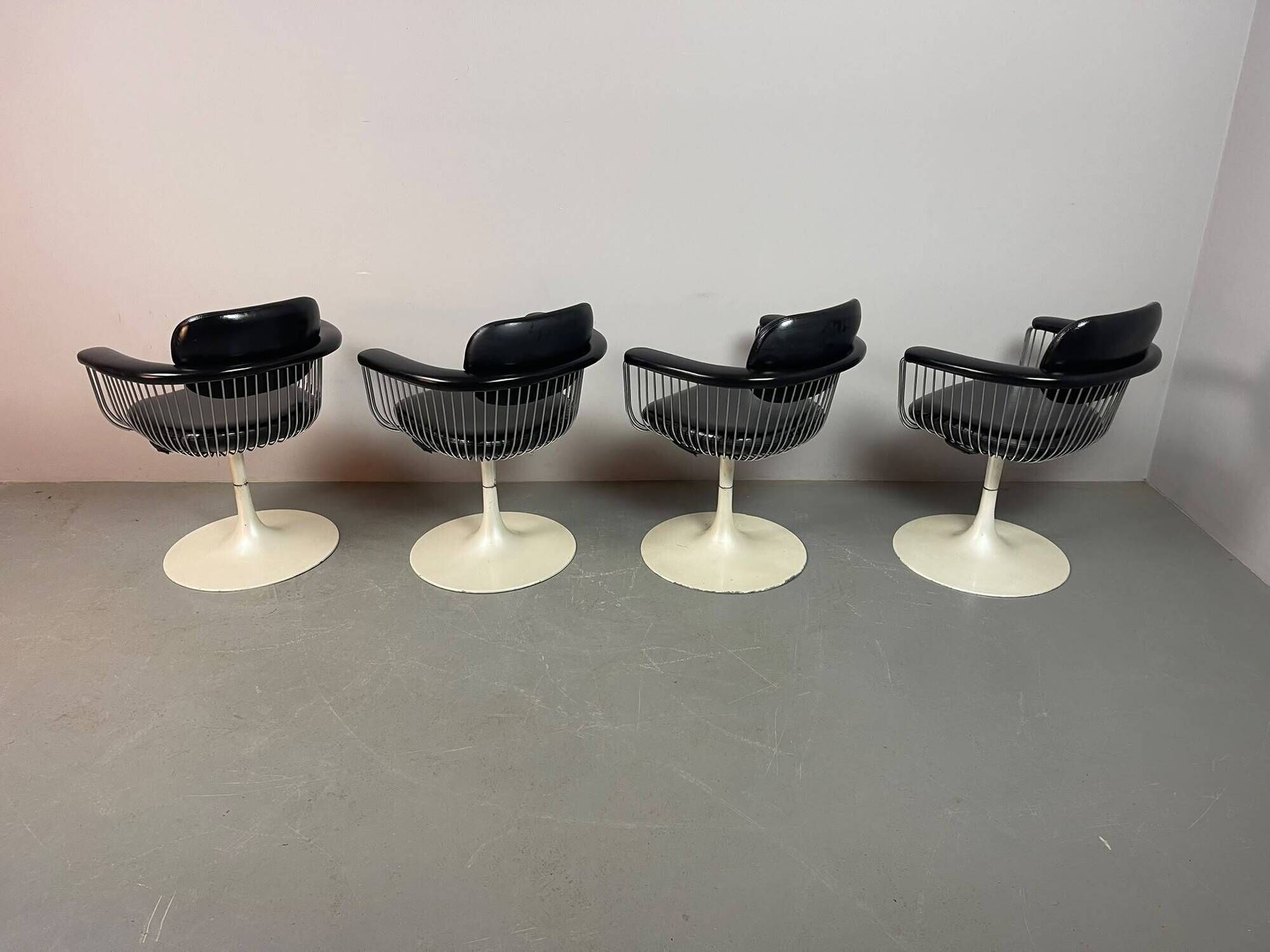 A striking set of four vintage swivel dining chairs