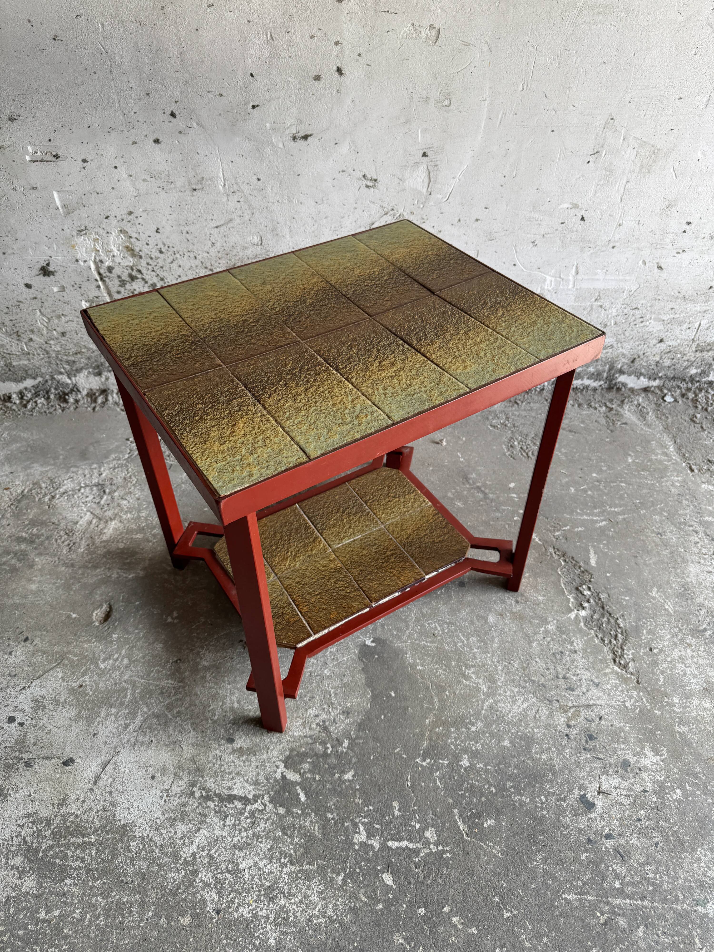 Vintage terracotta-red metal side table with glazed brown-green ceramic tile surfaces
