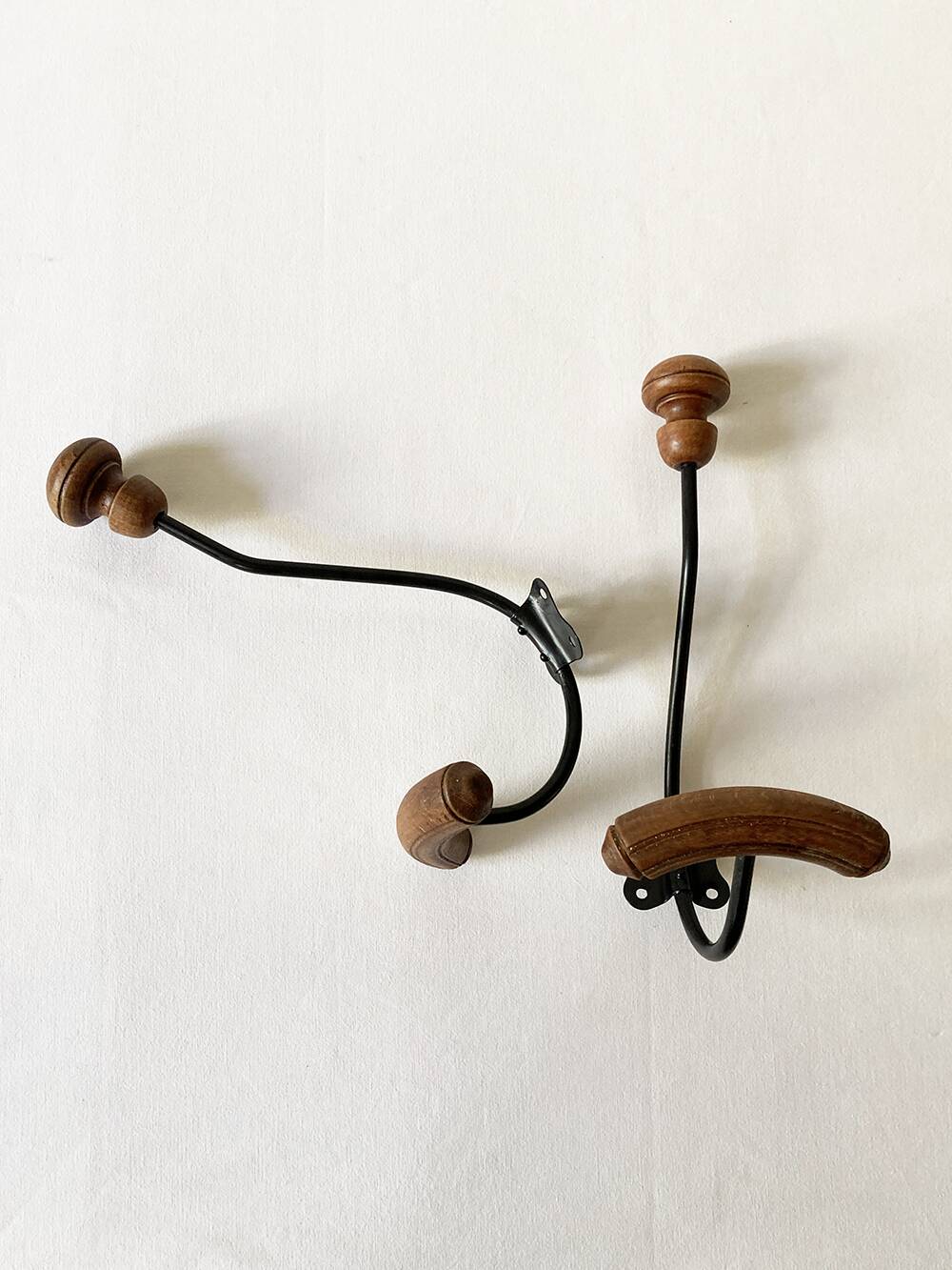 Pair of antique wooden and metal coat hooks