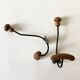 Pair of antique wooden and metal coat hooks