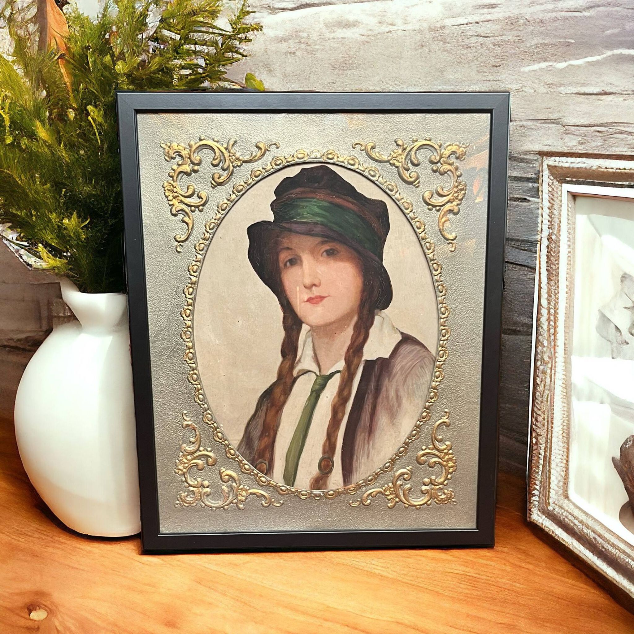 Old portrait of a young woman with braids and a hat, circa 1930