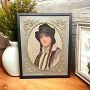 Old portrait of a young woman with braids and a hat, circa 1930