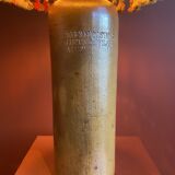 "Stoneware Bottle Lamp" with a multicoloured blue lampshade handwoven in India.