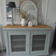 Vintage buffet on grey green wheels, 2 glass doors, wooden tray.