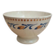 Old ironstone bowl with vintage blue and ochre decoration.