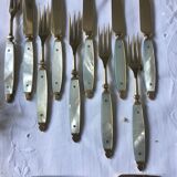 Old brass forks and knives and mother-of-pearl handle