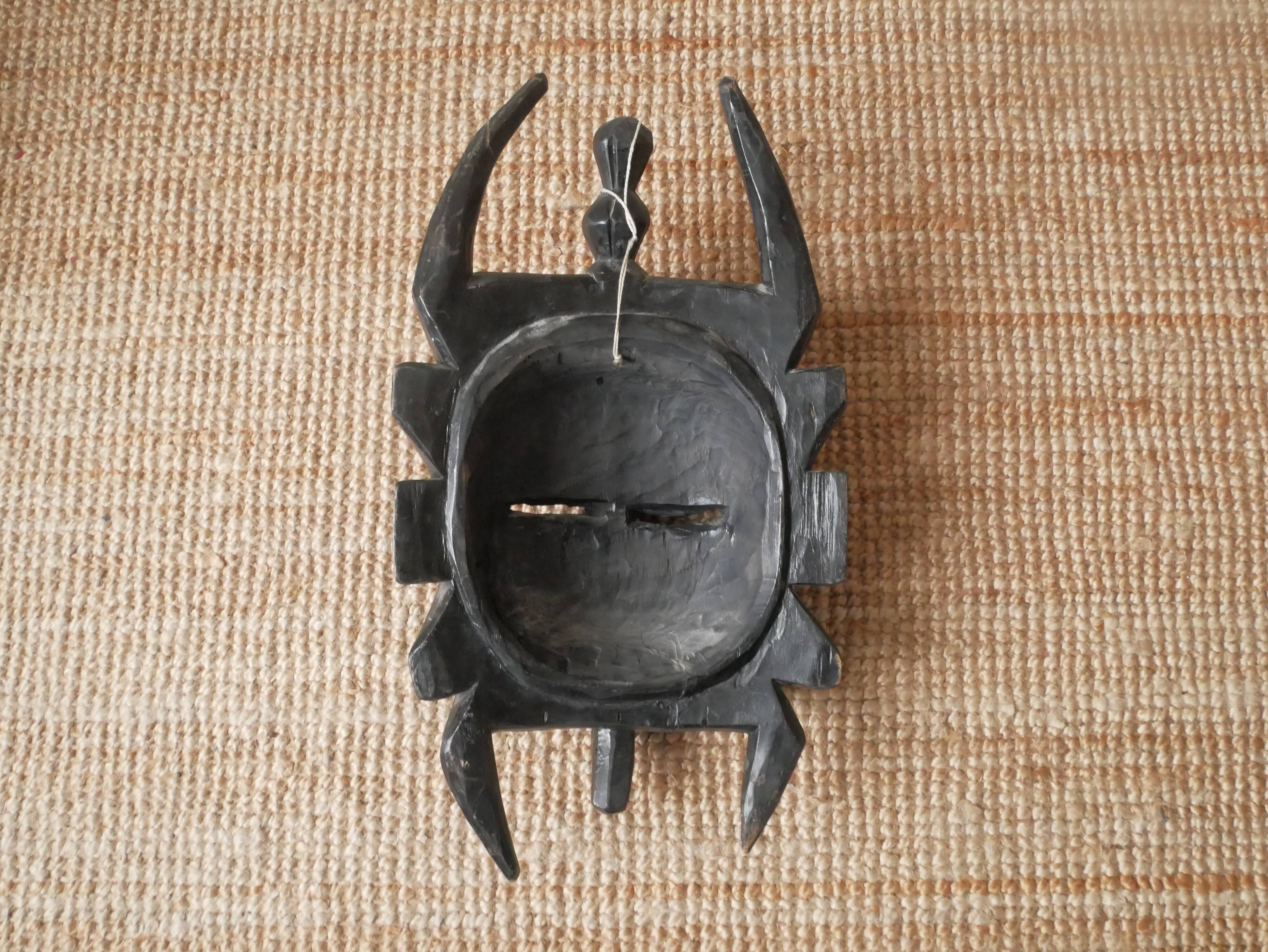 Decorative mask hand carved in tribal ethnic painted wood