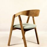 Vintage dining chair in light oak with natural linen pastel green fabric.