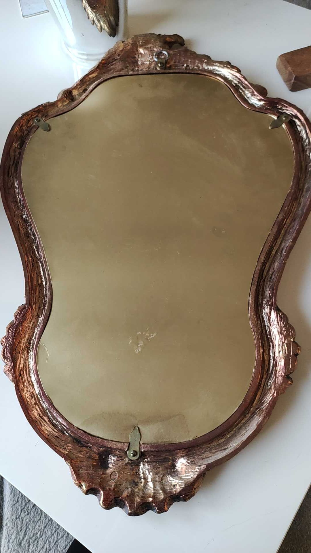 Pretty Baroque style mirror / Louis XV patinated with pink / golden copper reflections. Volutes, leafy shells