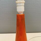 Ceramic table lamp with partial orange glaze.