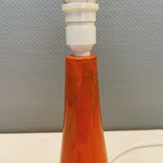 Ceramic table lamp with partial orange glaze.
