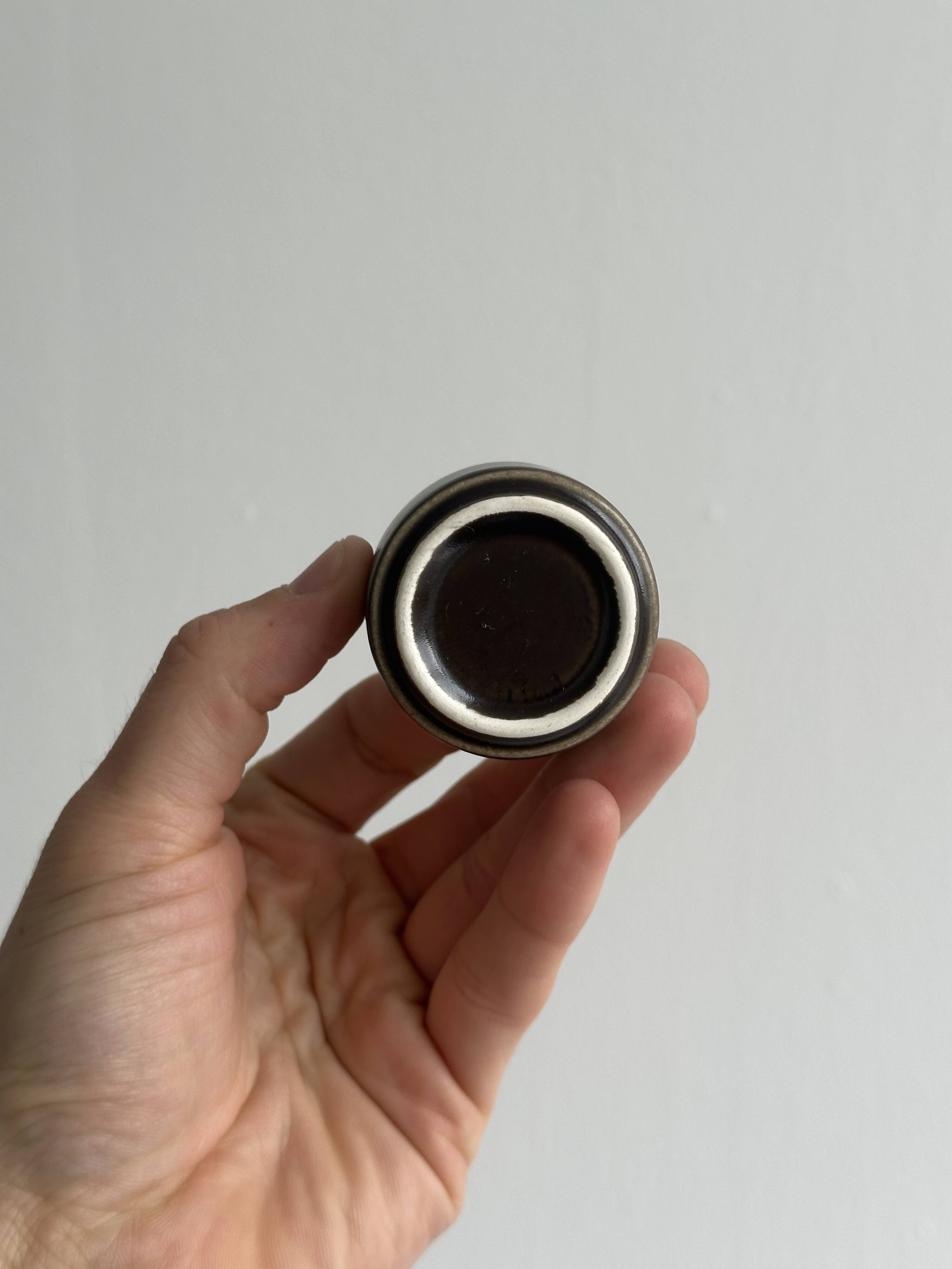 Set of 5 dark brown glazed ceramic egg cups.