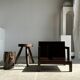 Small low armchair in varnished brown wood