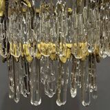 Antique chandelier in gilded bronze with crystal pendants.