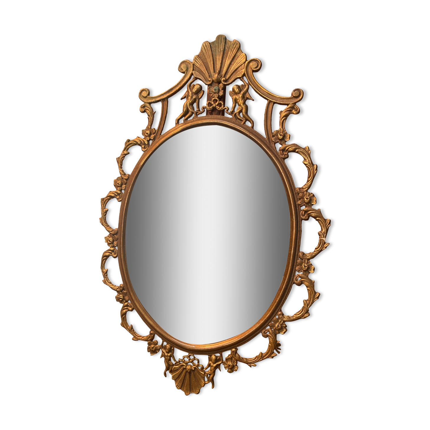 Oval mirror in gilded brass, figures of cherubs and moldings