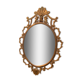 Miroir ovale en laiton doré , figures de chérubins et moulures