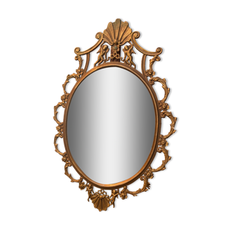 Miroir ovale en laiton doré , figures de chérubins et moulures