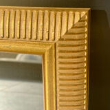 Mirror with striated and gilded decor