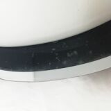 Oval wall lamp with mirror frame. 1980s 18x30cm