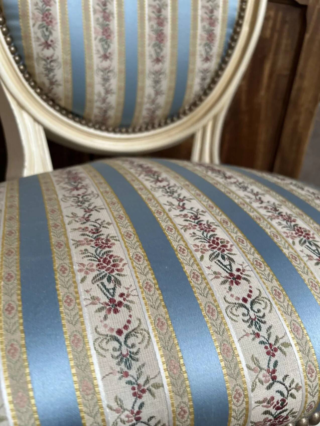 Pair of Louis XVI style chairs in painted wood and satin, classic elegance.