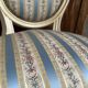 Pair of Louis XVI style chairs in painted wood and satin, classic elegance.