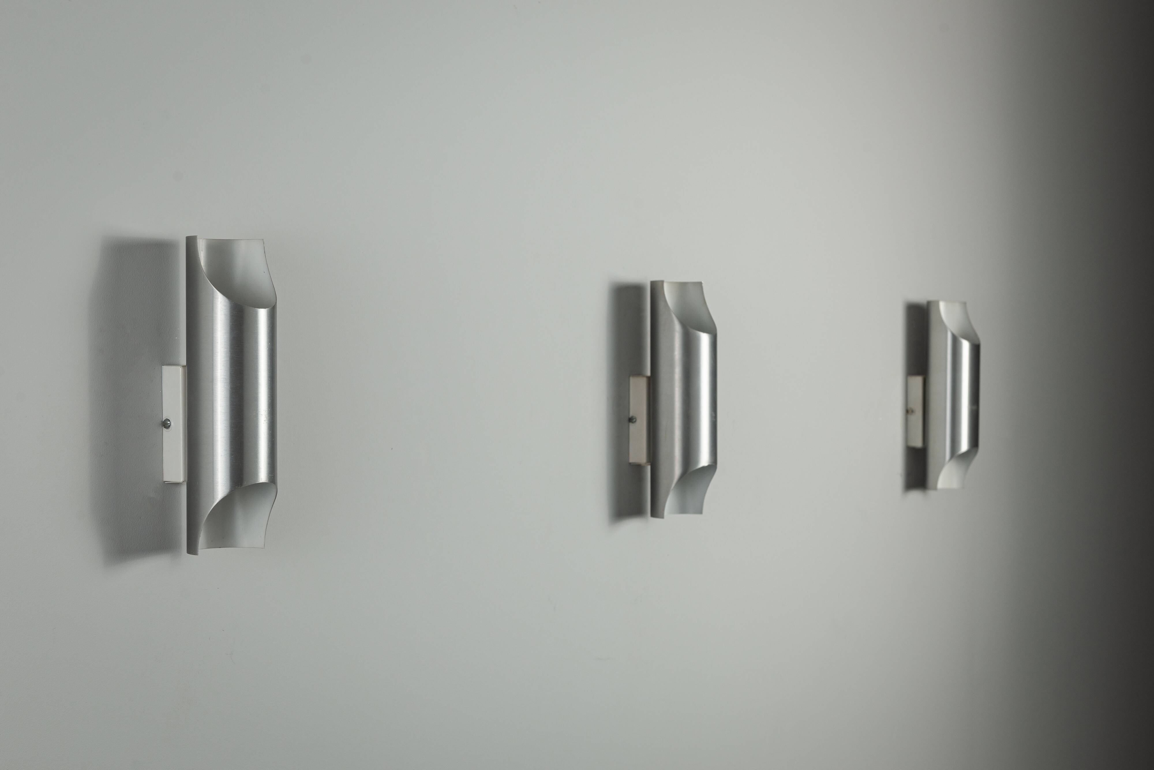 Set of three aluminium cylindrical wall lamps