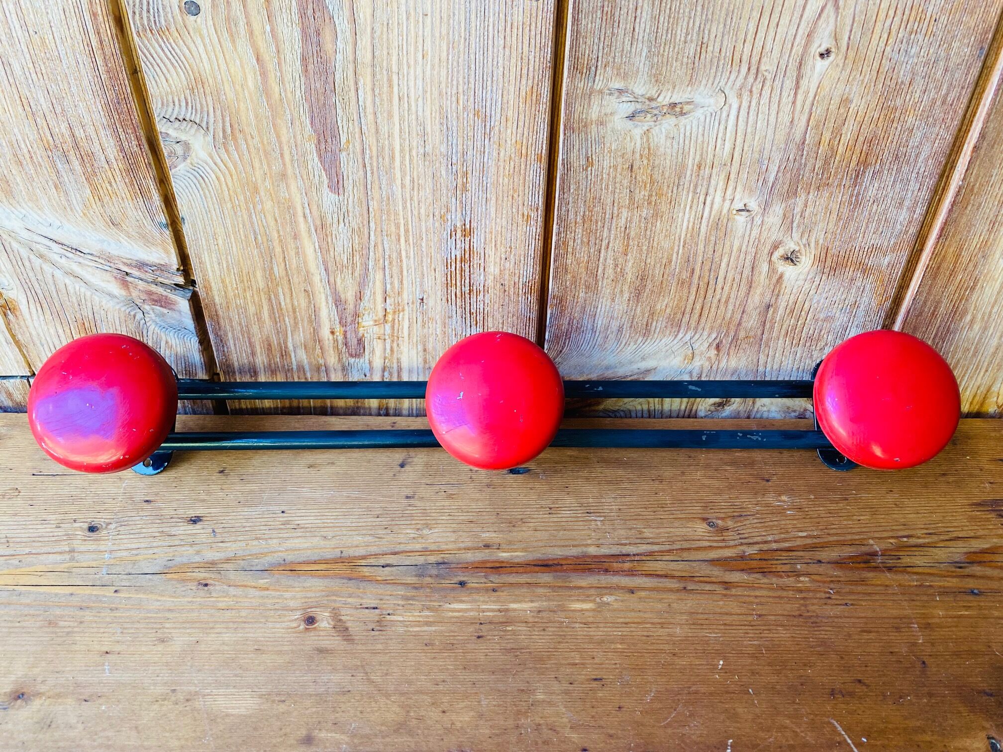 Wall coat rack in vintage red metal.