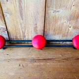 Wall coat rack in vintage red metal.