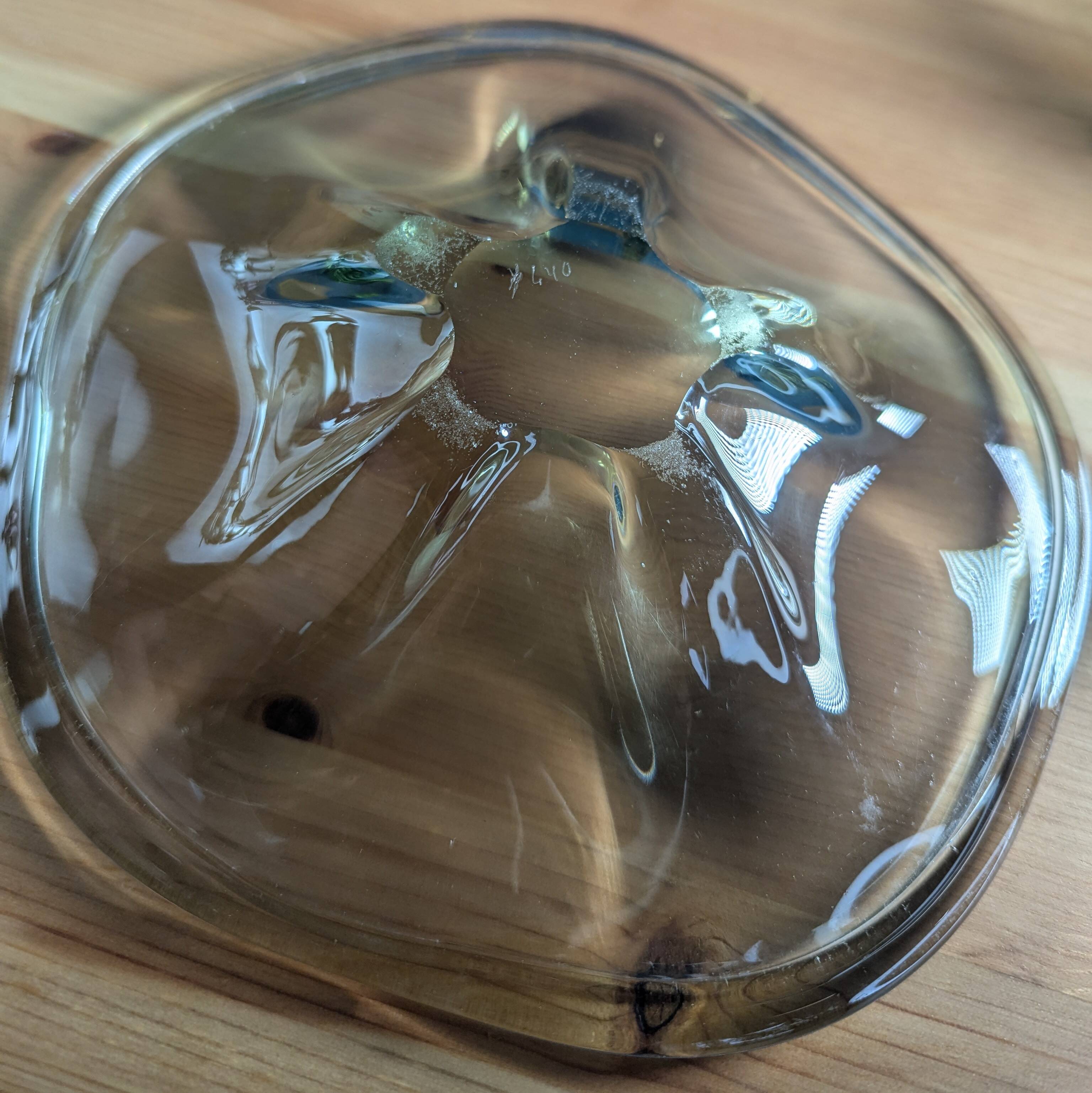 4 wavy glass bowls plates in smoked green design, signed and numbered
