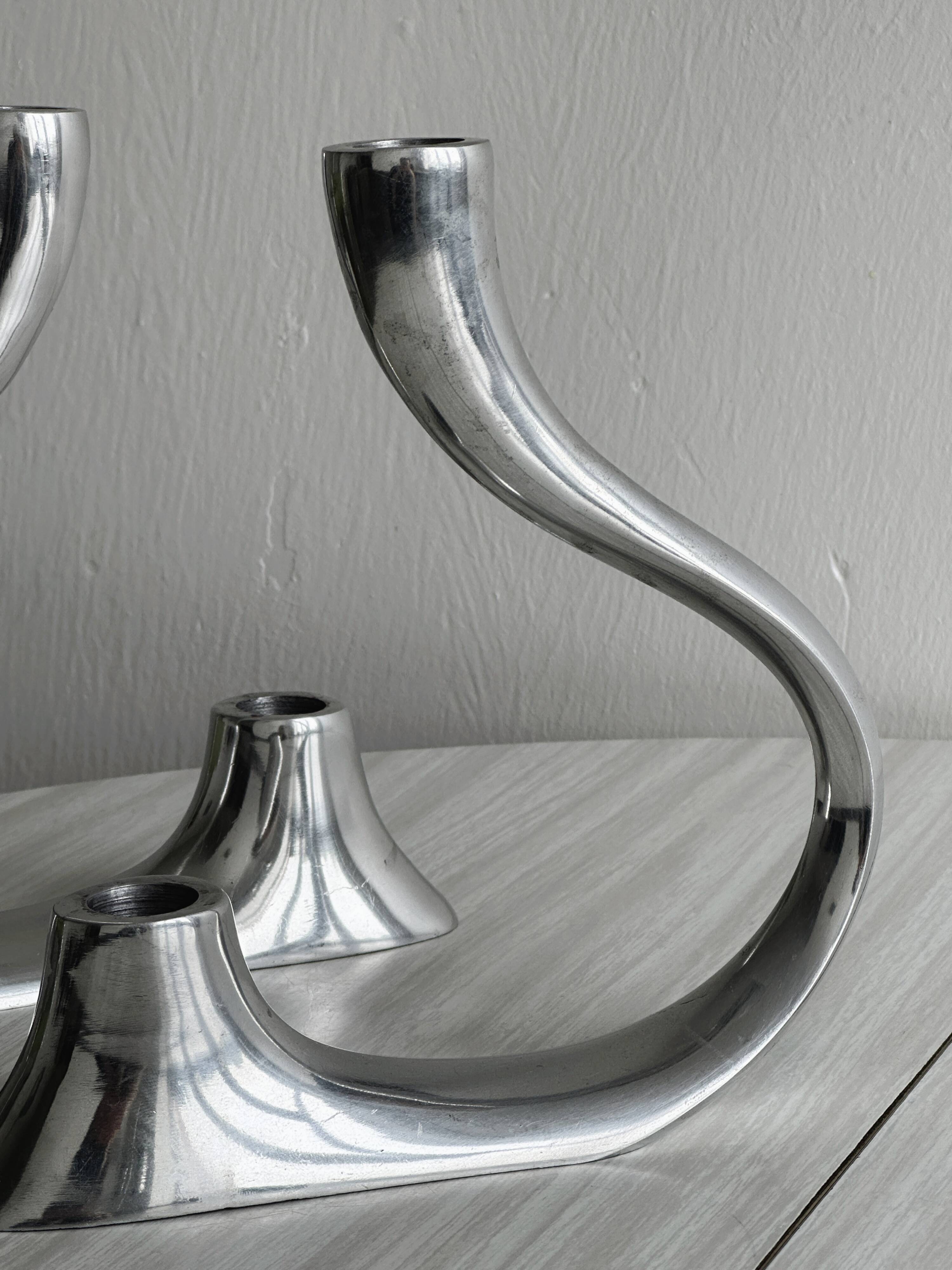 Pair of designer candlesticks in chromed metal