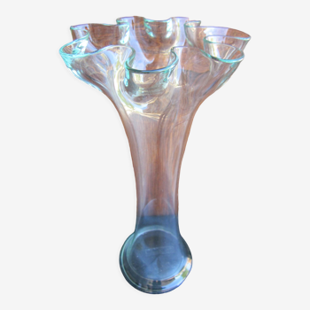 Elongated transparent glass vase in the shape of a flower