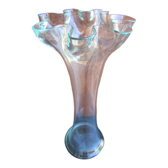 Elongated transparent glass vase in the shape of a flower