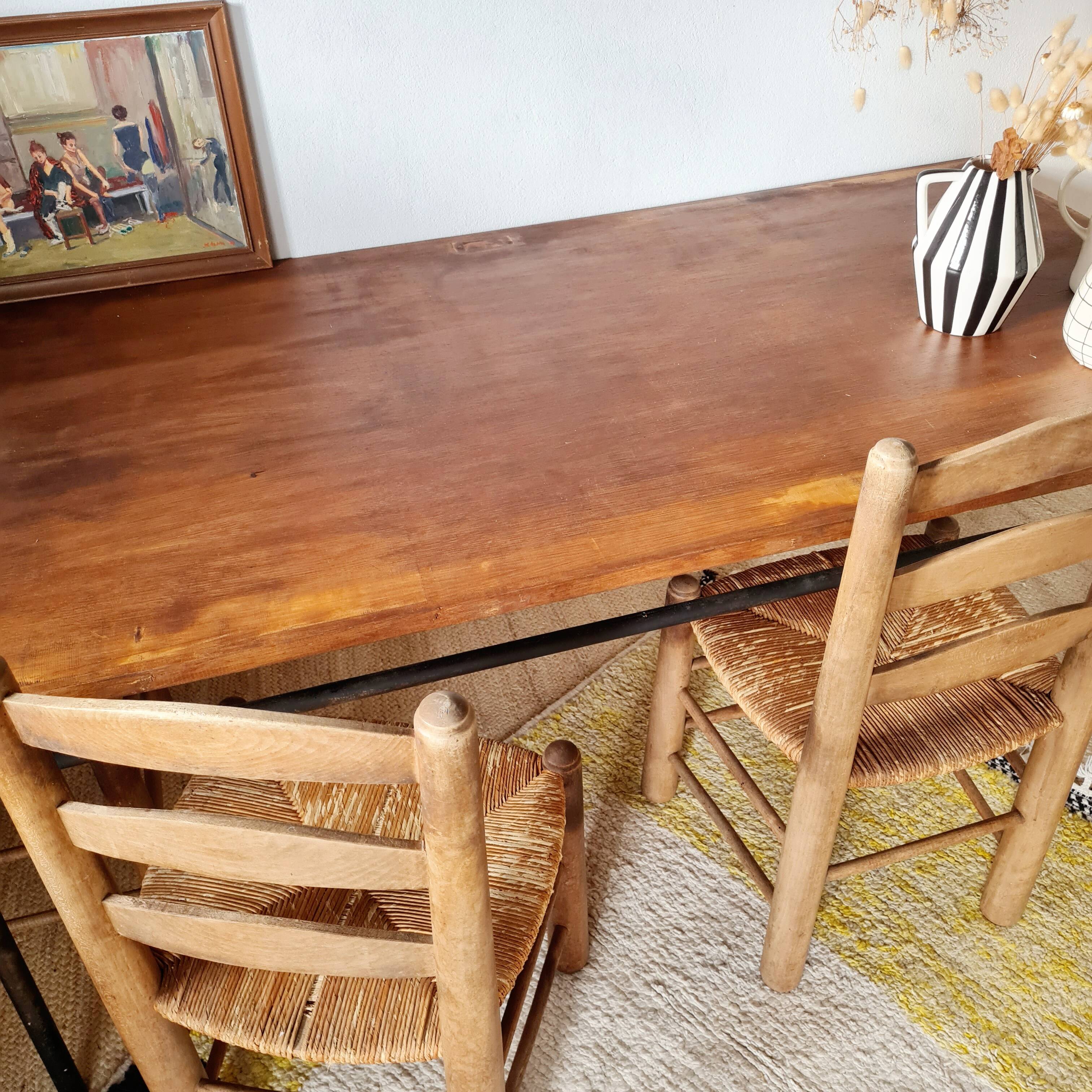 Table with tubular metal legs and wooden top.