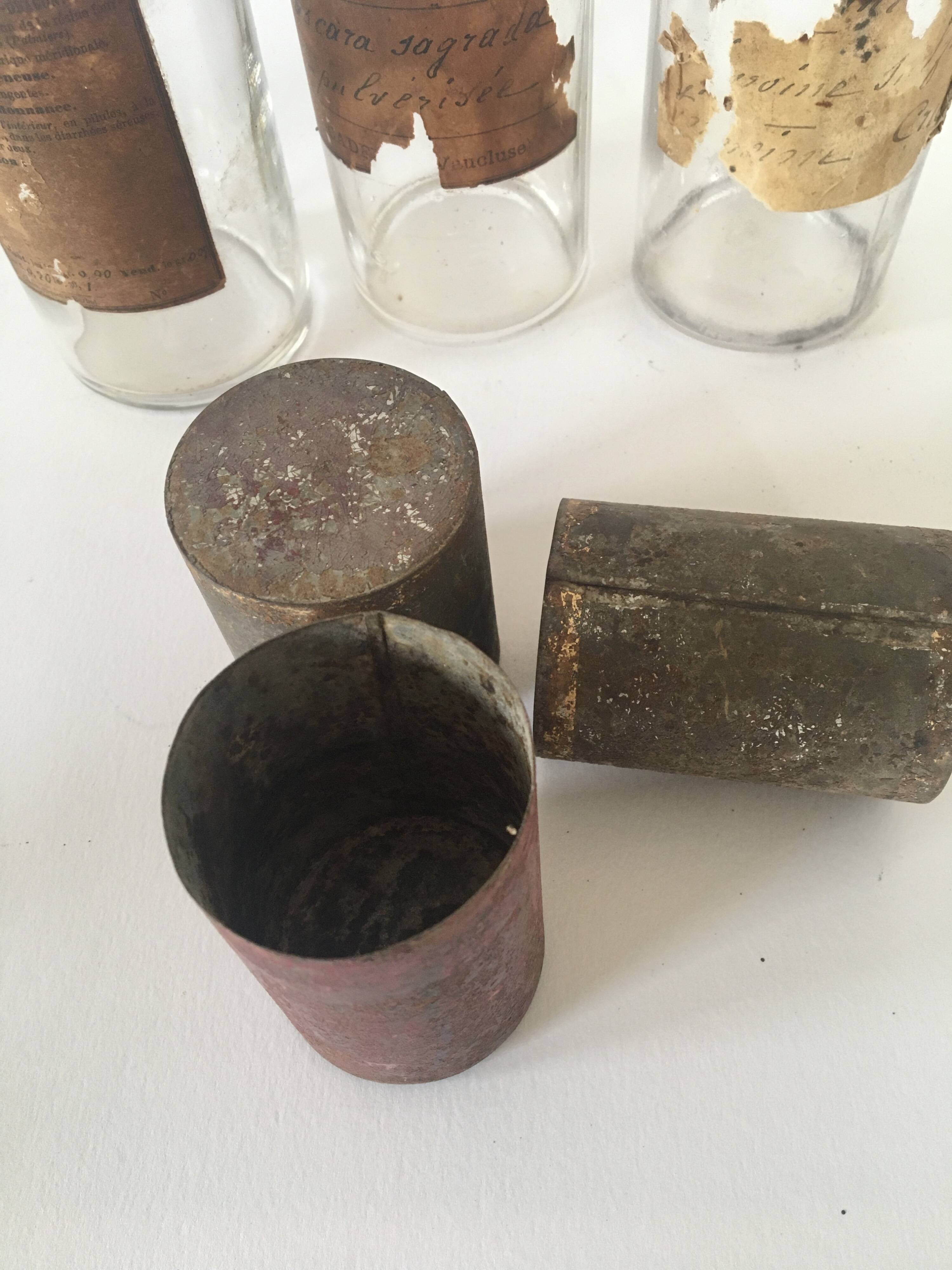 Trio apothecary bottles, painted metal caps