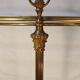 Old golden brass towel rack on baroque style foot