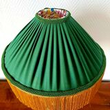 Green ceramic lamp with a vintage pleated fringe shade.