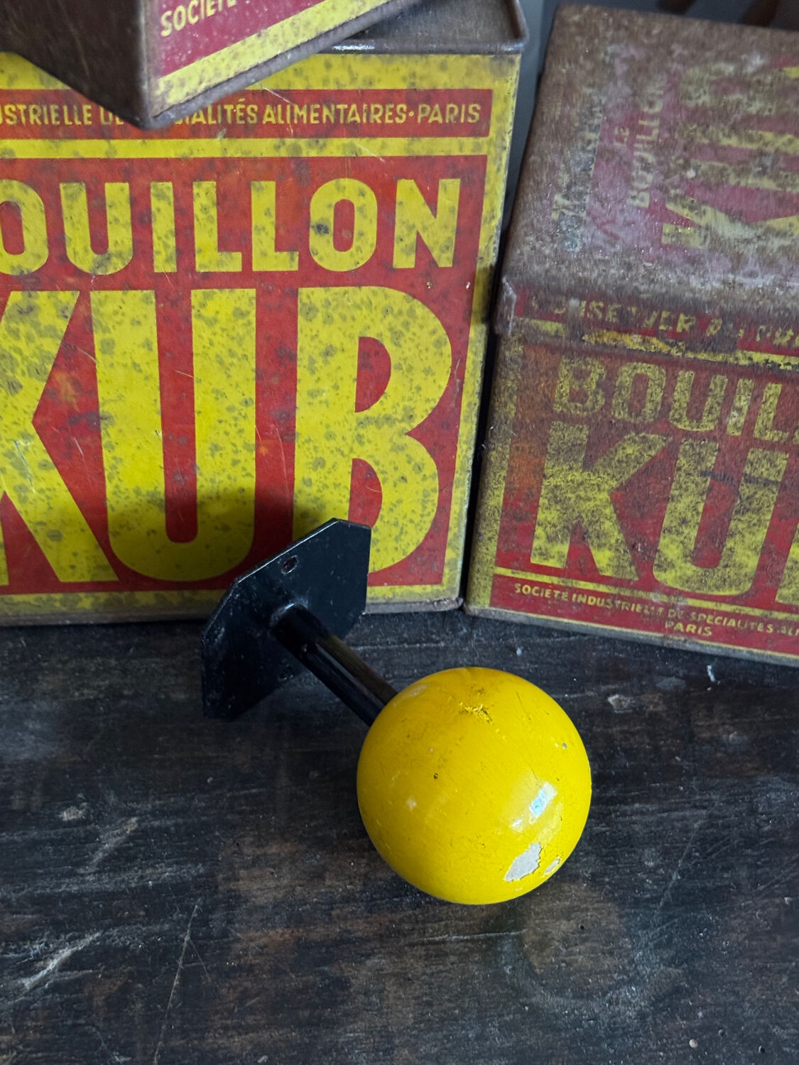 Vintage yellow wooden wall-mounted ball coat hook.