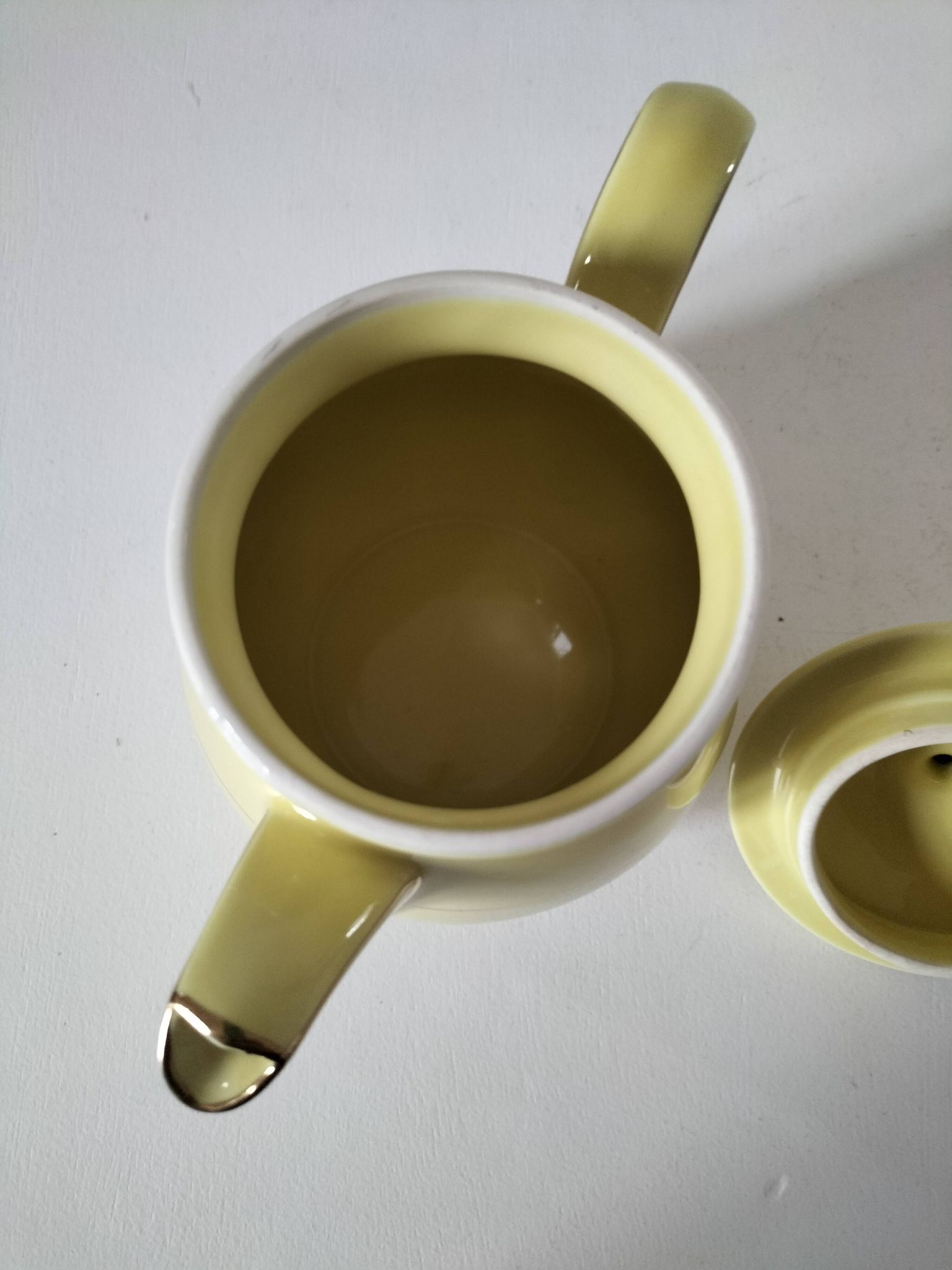 Vintage teapot in pastel yellow earthenware with gold trim