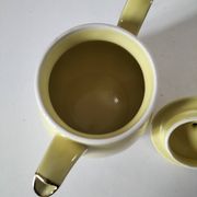Vintage teapot in pastel yellow earthenware with gold trim
