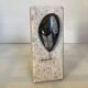 An asymmetrical travertine and fossil bookend.