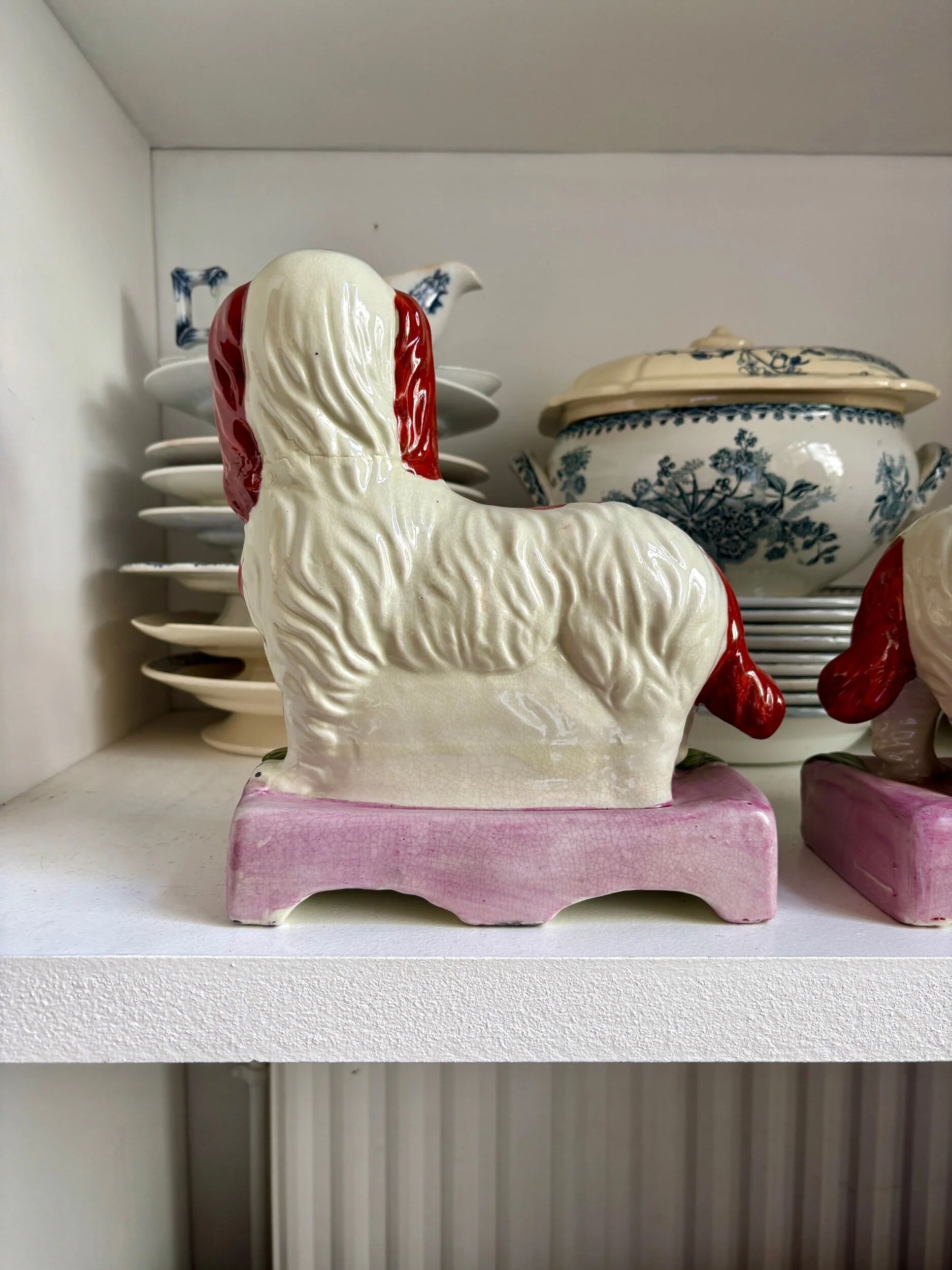 Pair of Staffordshire porcelain Cavalier King Charles dogs on terrace, 19th century.