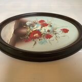 Oval painting of a bouquet of flowers, oil on panel.