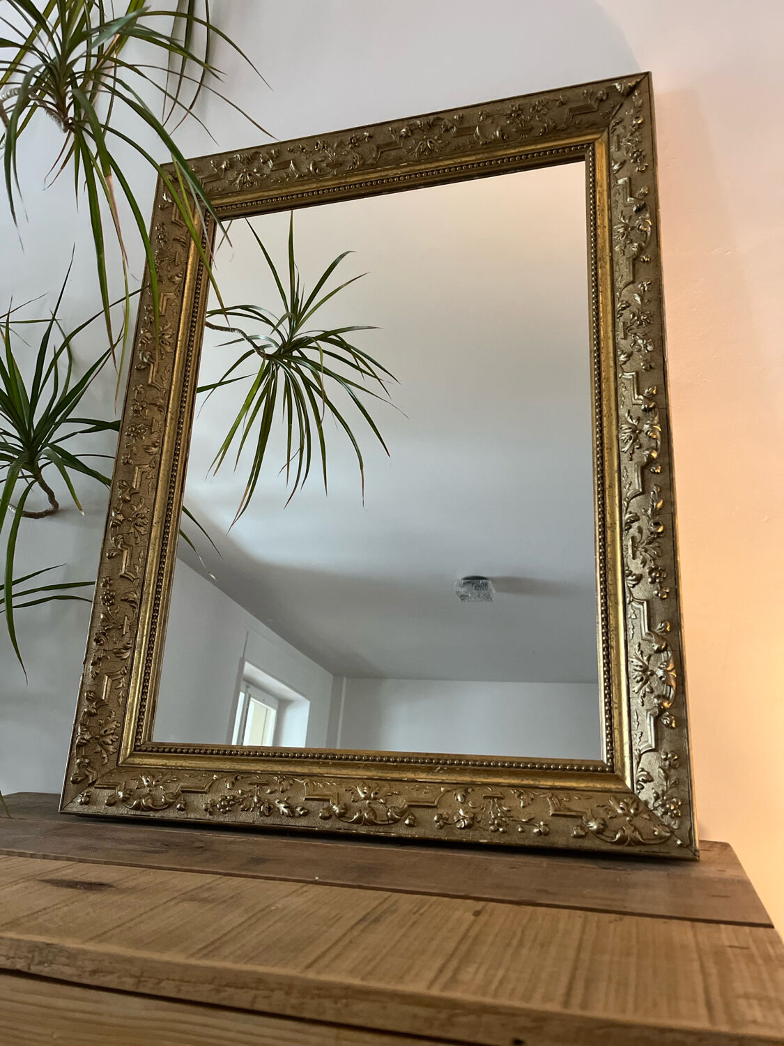 Gilded mirror with antique wood and stucco frame