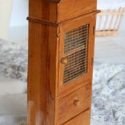 Vintage wooden shelf with drawers and mesh door.